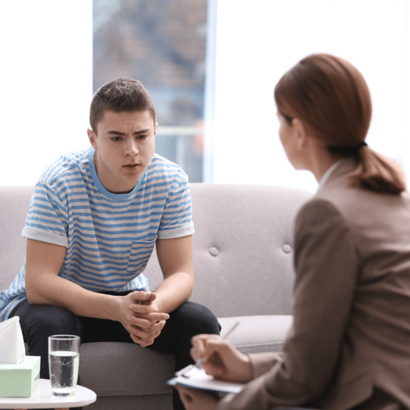 Trauma Counseling - Teen sitting with counselor